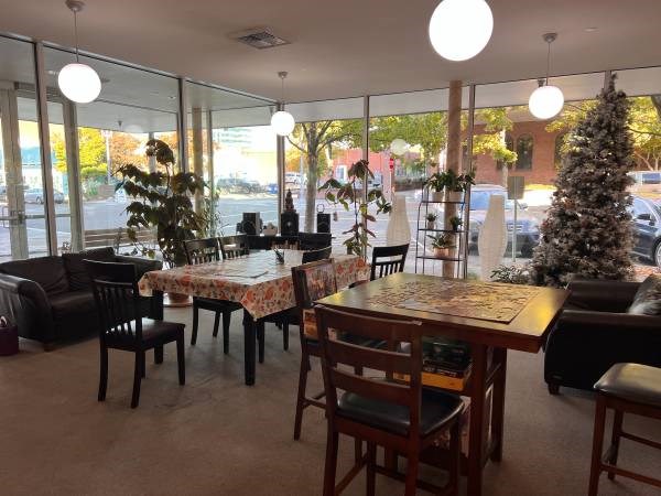 A dining room with a table set for six people.
