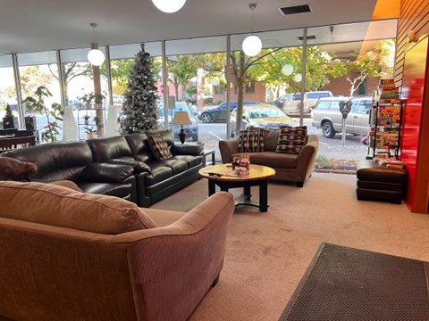 A living room with a brown couch and a coffee table.