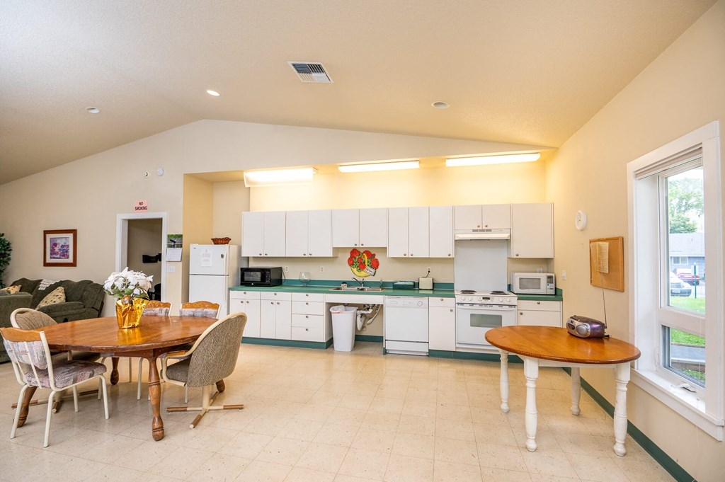 a kitchen and dining room with a table and chairs