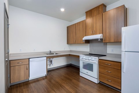 A kitchen with wooden cabinets and white appliances.