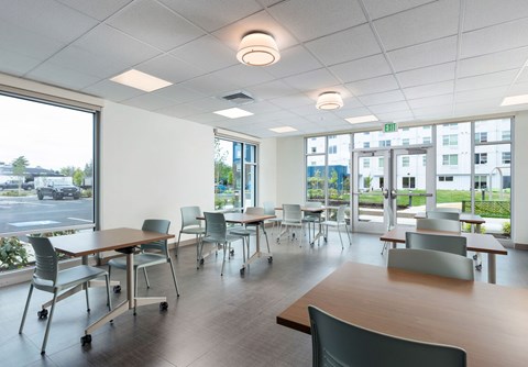 A conference room with a long table and chairs.