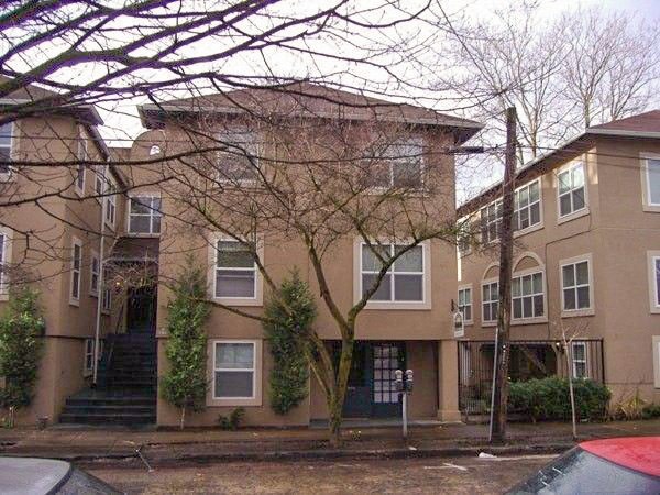 the outside of three buildings with trees in front