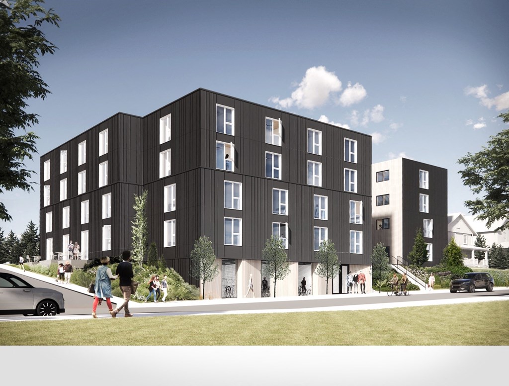 A modern apartment building with people walking in front.