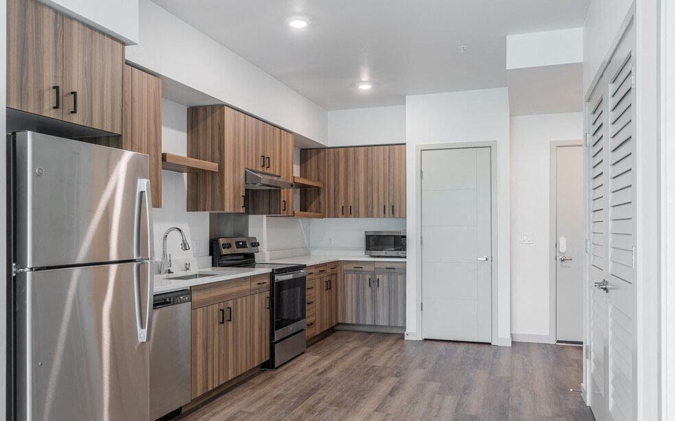 a kitchen with wooden cabinets and stainless steel appliances