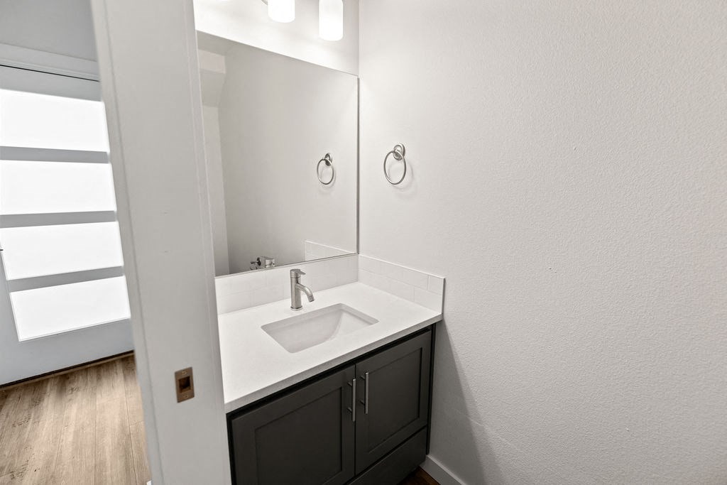 a white bathroom with two sinks and a mirror