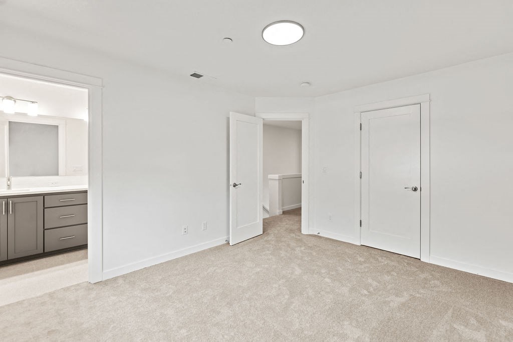 a bedroom with a bathroom and a closet