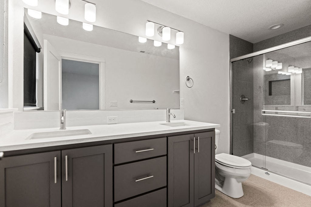 a bathroom with a sink toilet and a shower