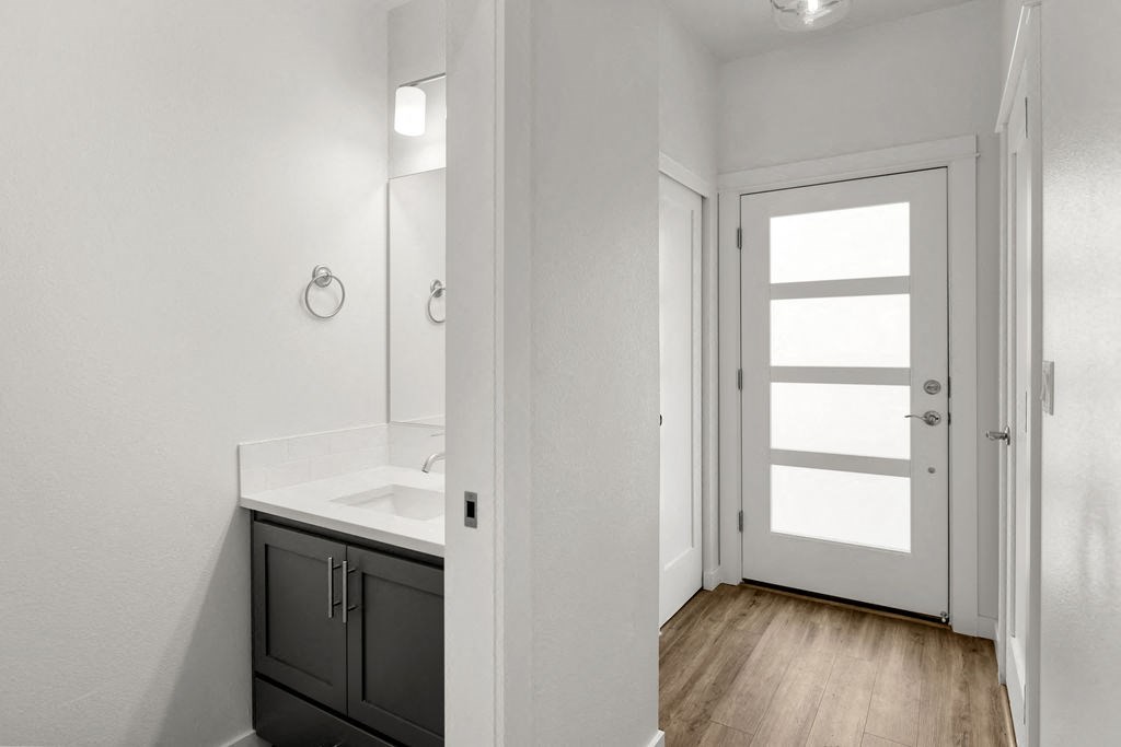 an empty bathroom with a sink and a door