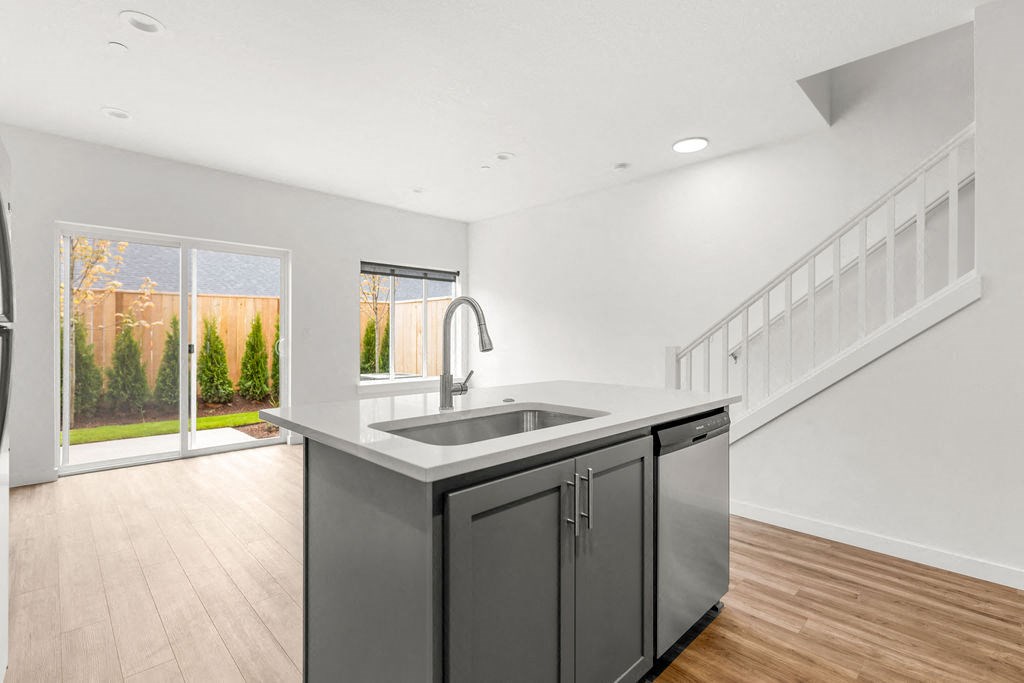 an empty kitchen with a sink and a window
