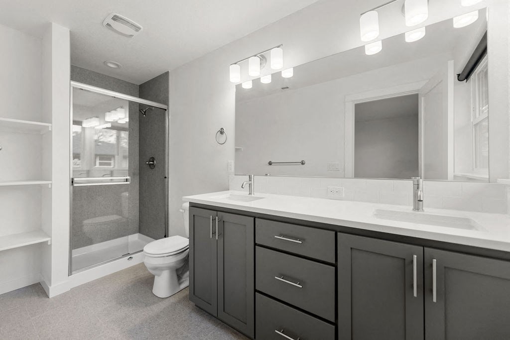 a bathroom with a sink toilet and a shower