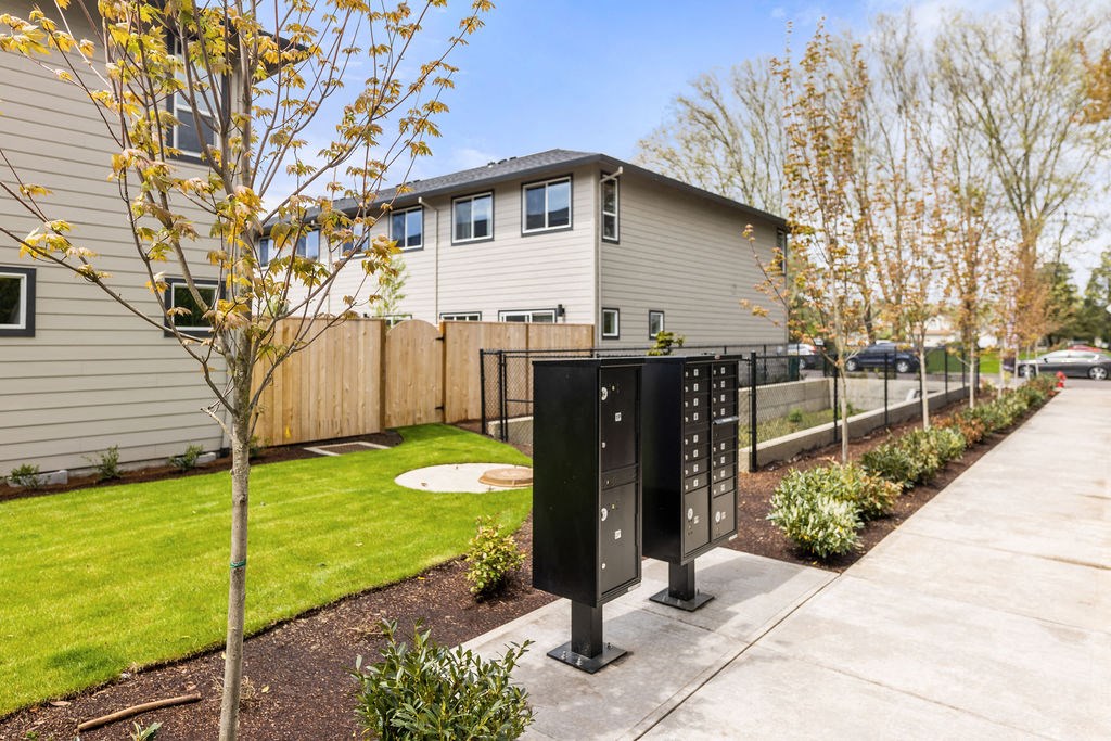 the front of a house with a sidewalk and a mailbox