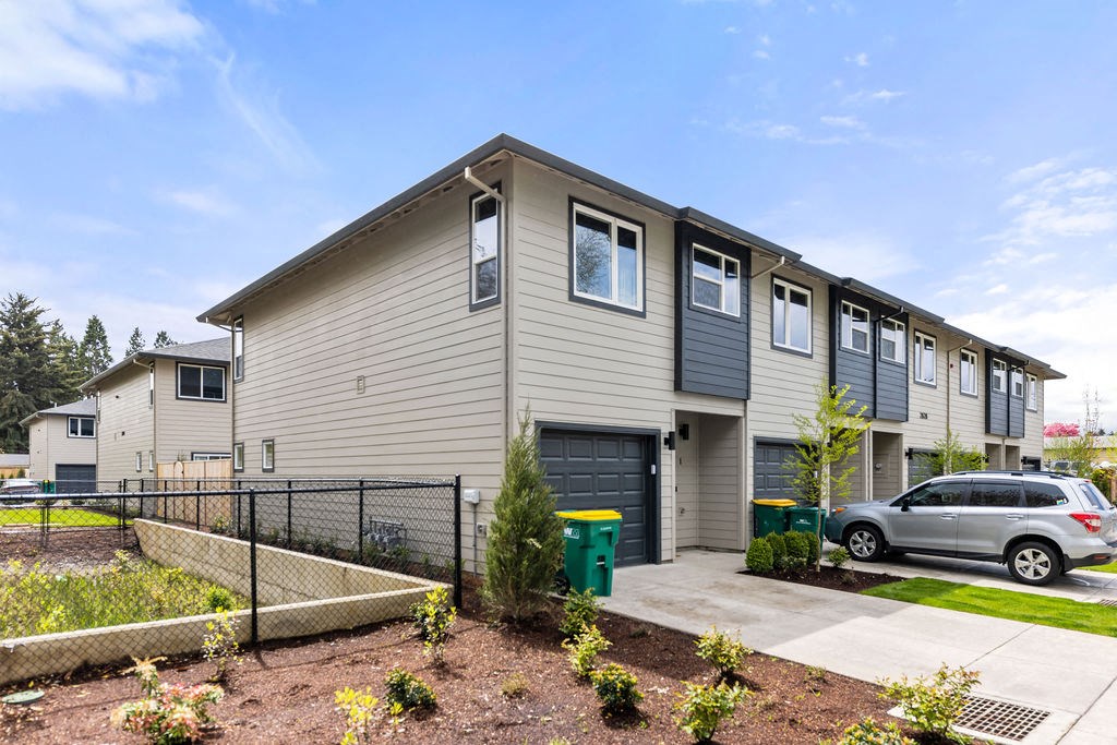 an apartment building with a car parked in front of it