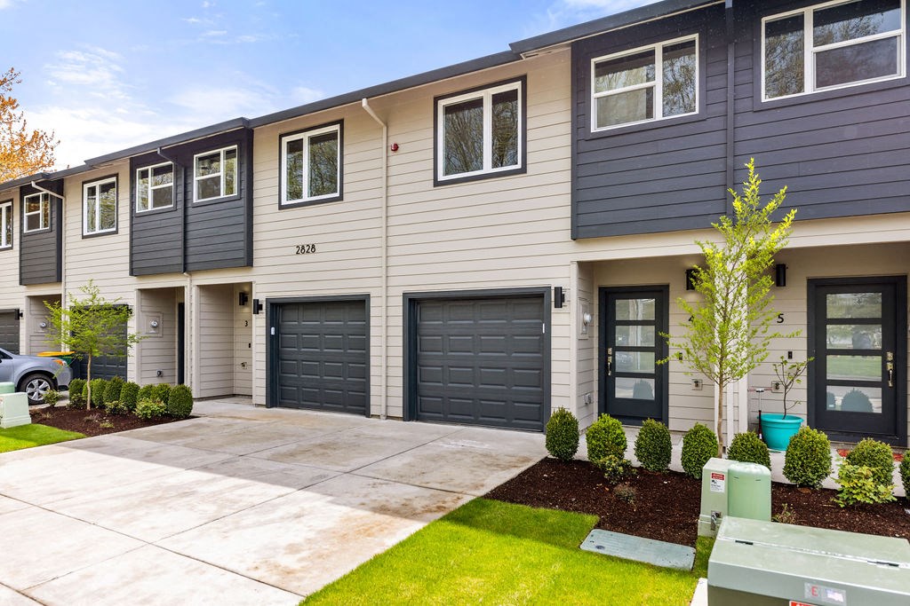 the front of a house with two garage doors