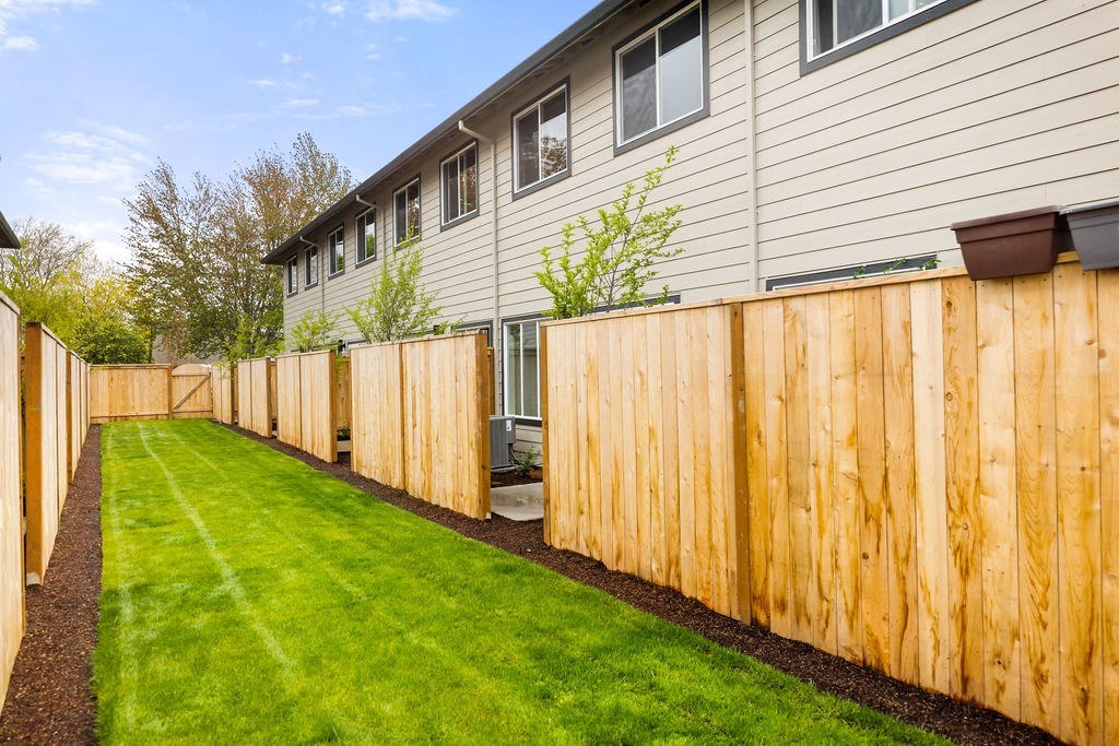 a wooden fence in front of a house
