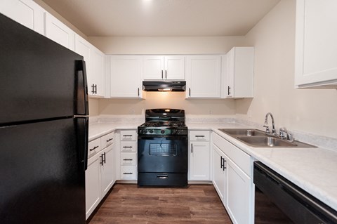 the preserve at ballantyne commons apartment kitchen with black stove and refrigerator