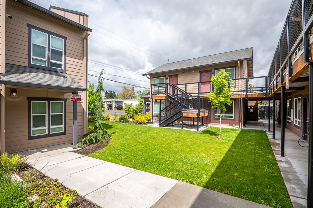the backyard of a house with a yard and a staircase