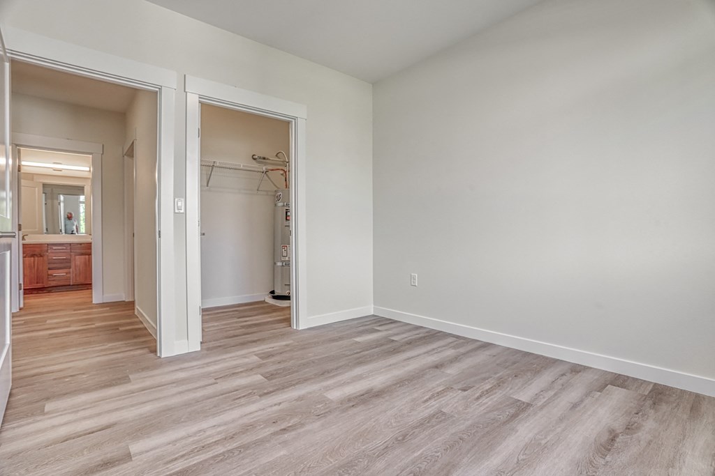 a bedroom with hardwood flooring at the oxford at estonia apartments in san an