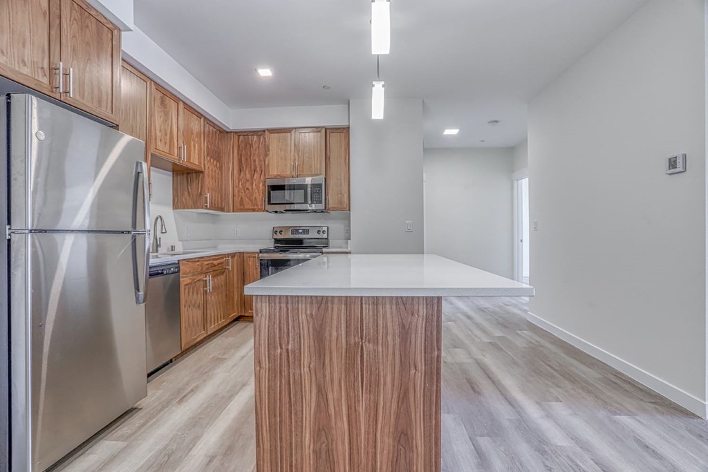 a kitchen with wooden cabinets and stainless steel appliances