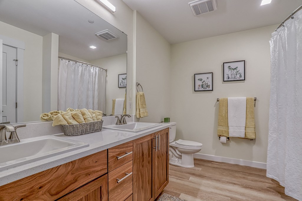 a bathroom with a toilet sink and shower