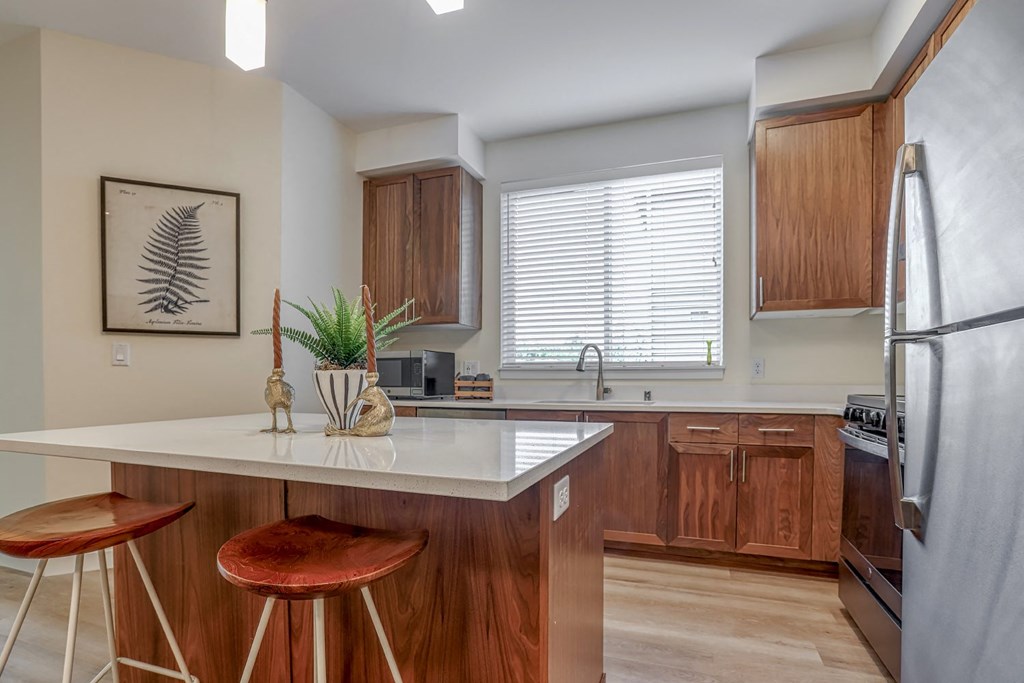 a kitchen with wooden cabinets and a white counter top
