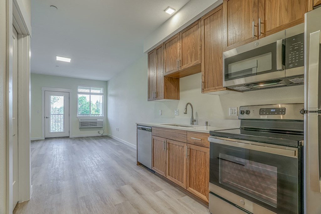 a kitchen with wooden cabinets and stainless steel appliances
