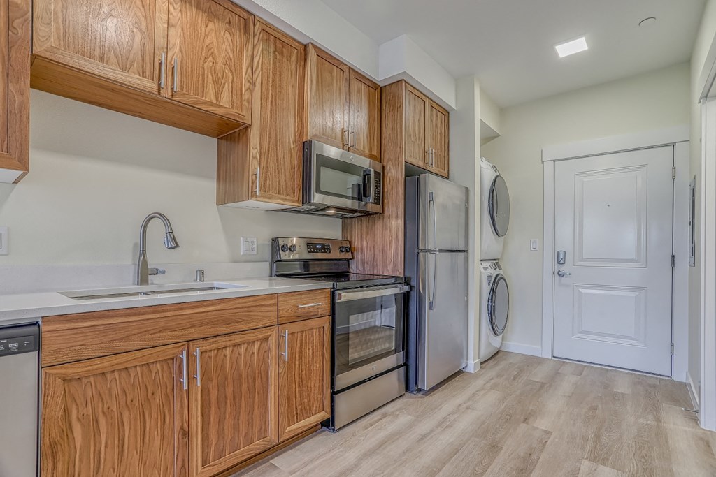a kitchen with wooden cabinets and stainless steel appliances