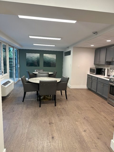 A dining room with a table and chairs.