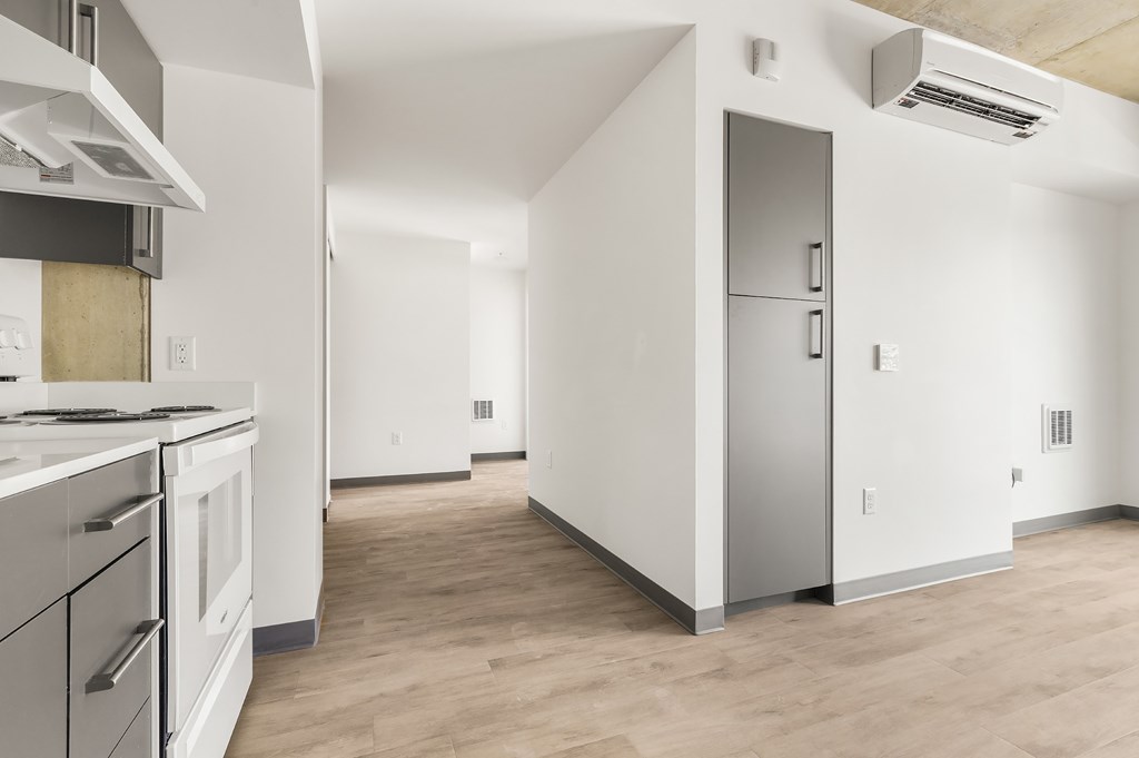 A kitchen with a refrigerator, stove, and oven.