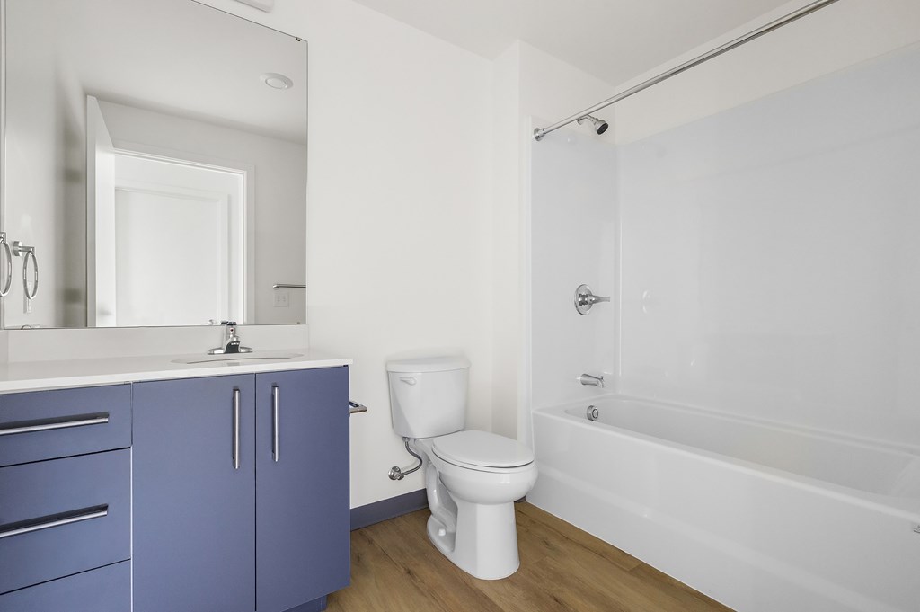 A white toilet sits next to a white sink in a bathroom.