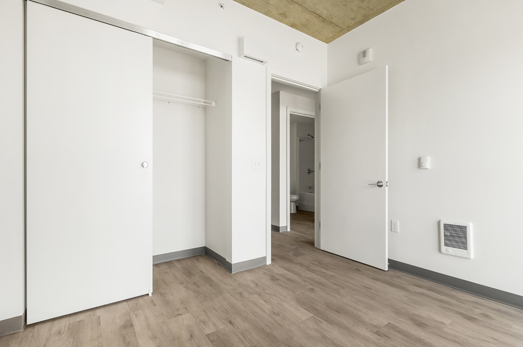 A white door is open to a hallway.