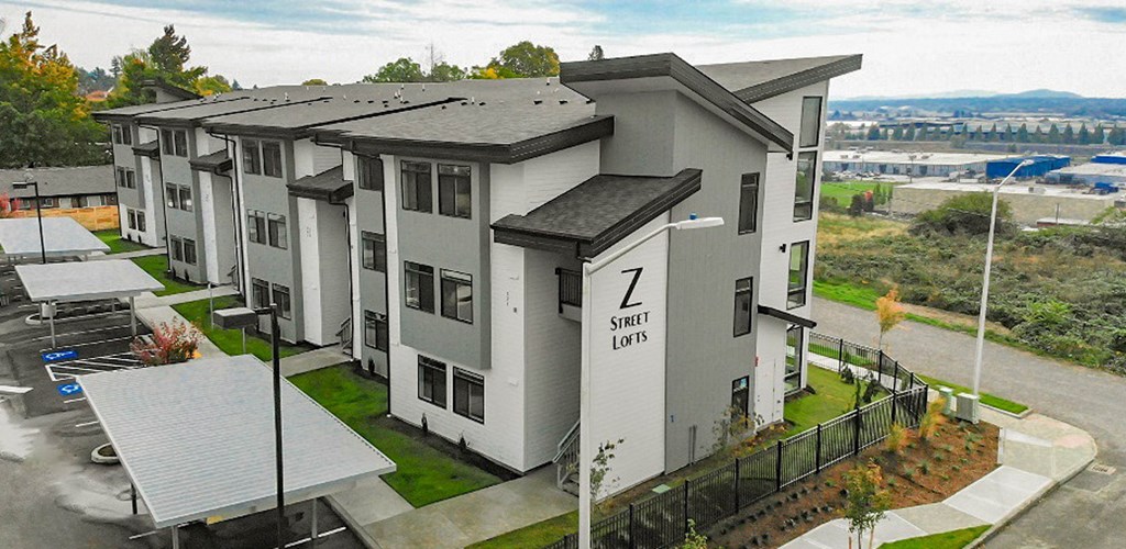 an aerial view of a row of apartment buildings on a city street