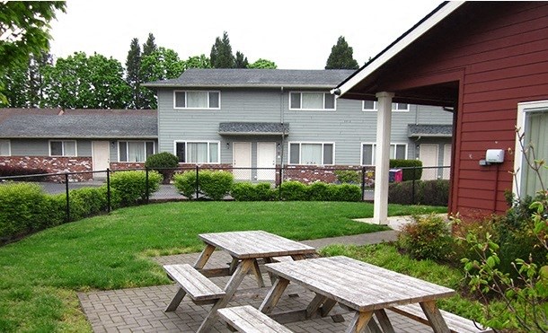 a group of picnic tables outside of a building