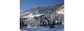 a cabin in the mountains covered in snow