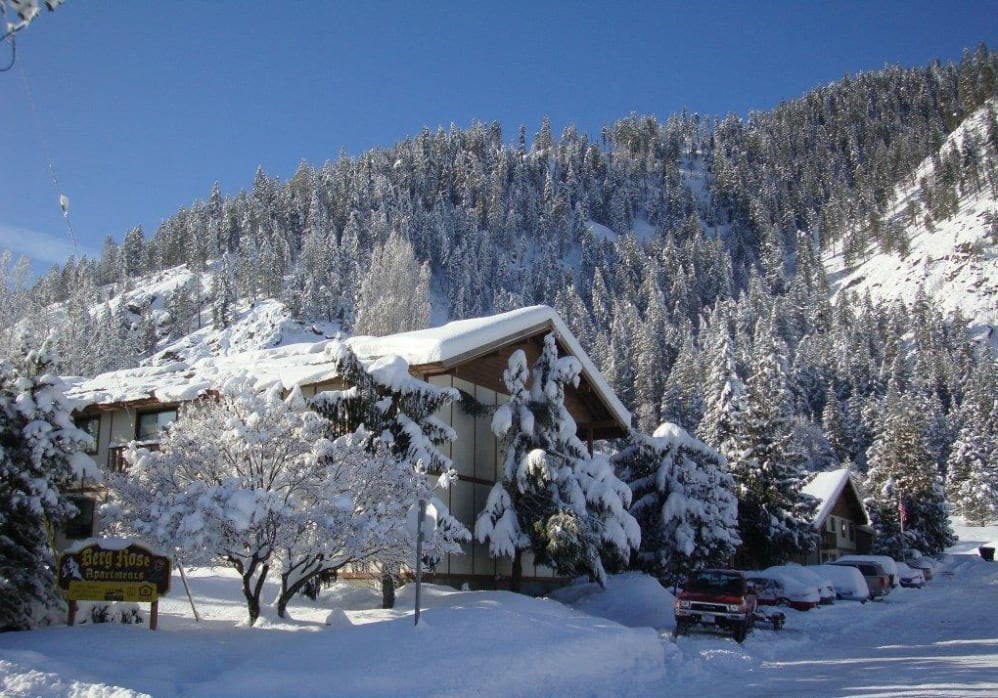 a cabin in the mountains covered in snow