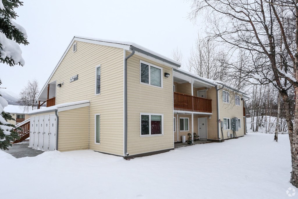 a view of the back of the house in the snow