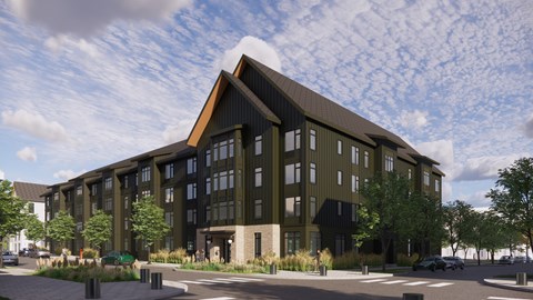 A modern building with a dark facade and large windows.