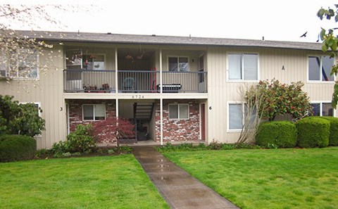Apartment building with a green lawn in front.