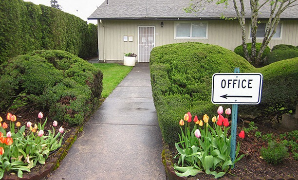a sign for an office in front of a house