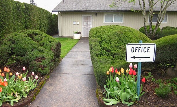 a sign for an office in front of a house