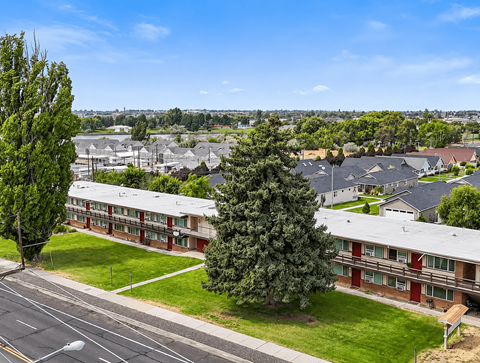 A view of a residential area with houses and trees.