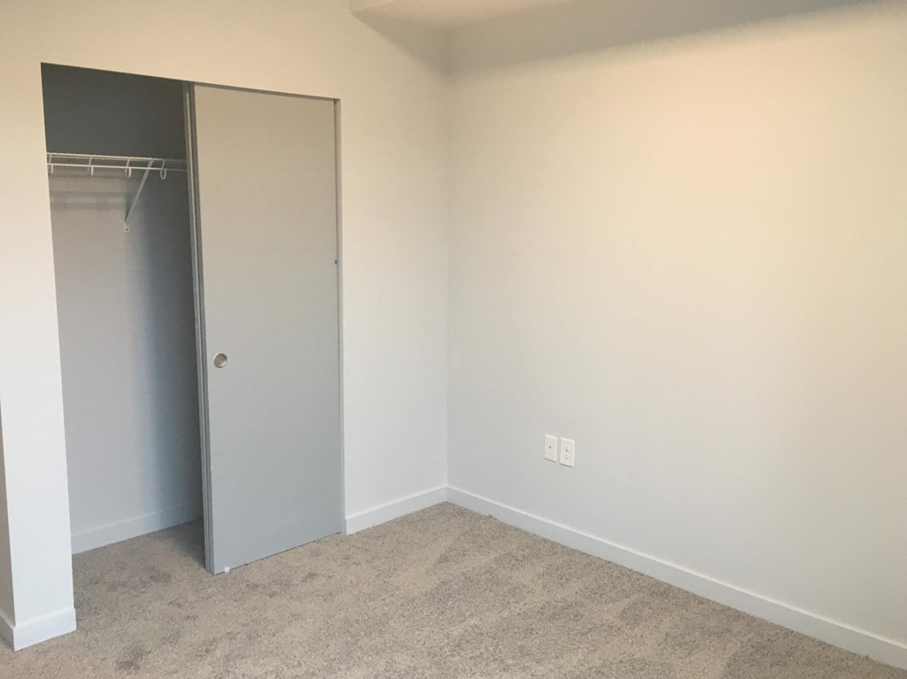 a room with a closet and an open door