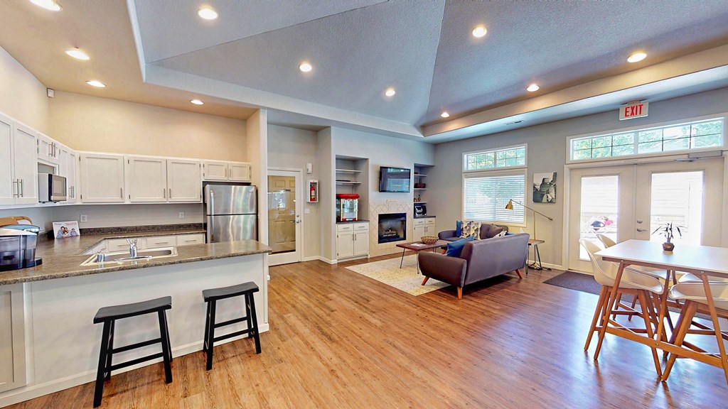 an open living room with a kitchen and a living room