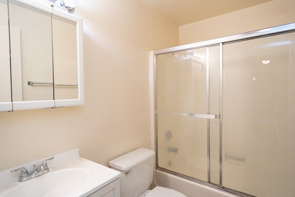 a bathroom with a toilet sink and shower