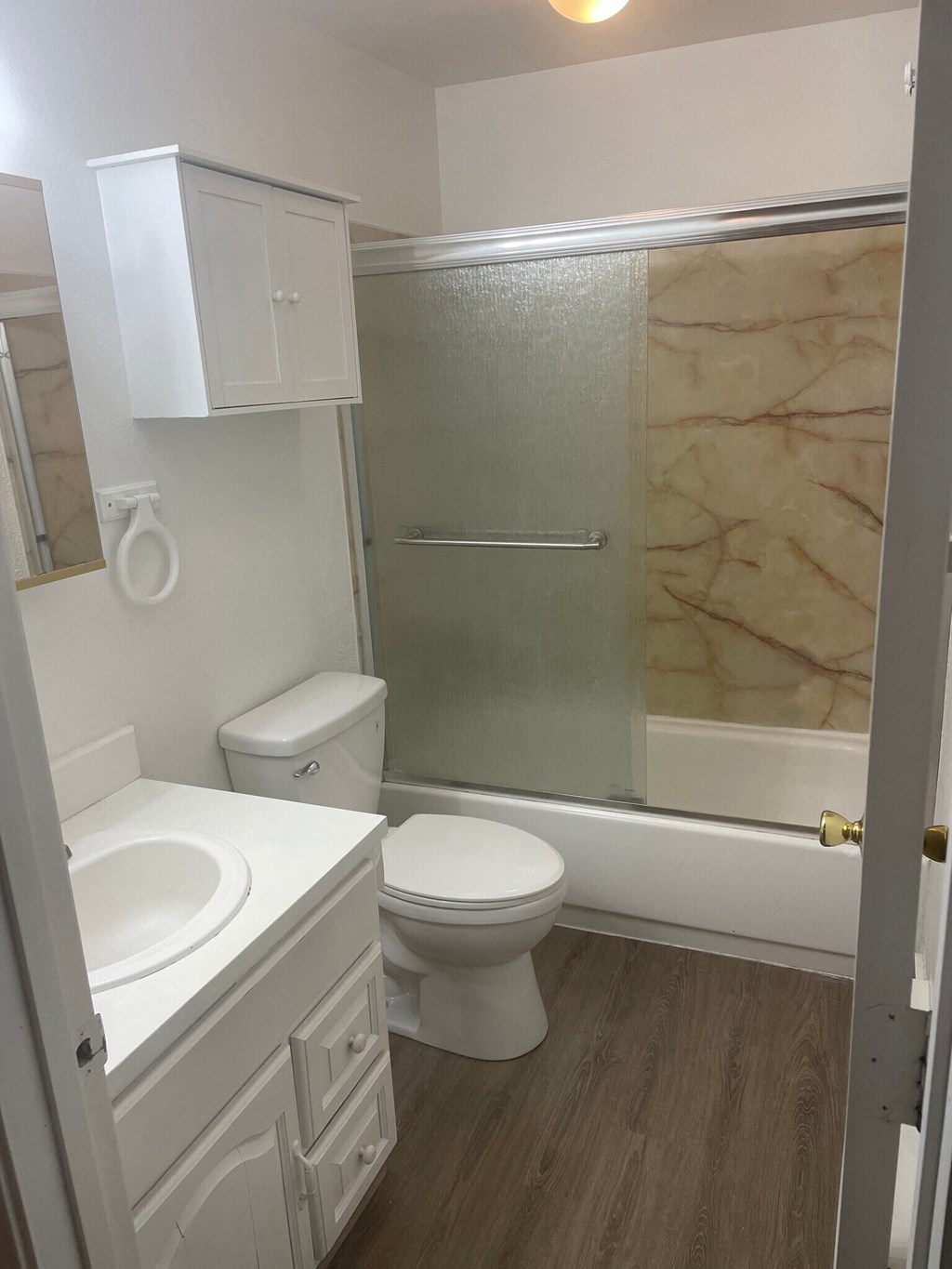 a small bathroom with a sink toilet and bathtub