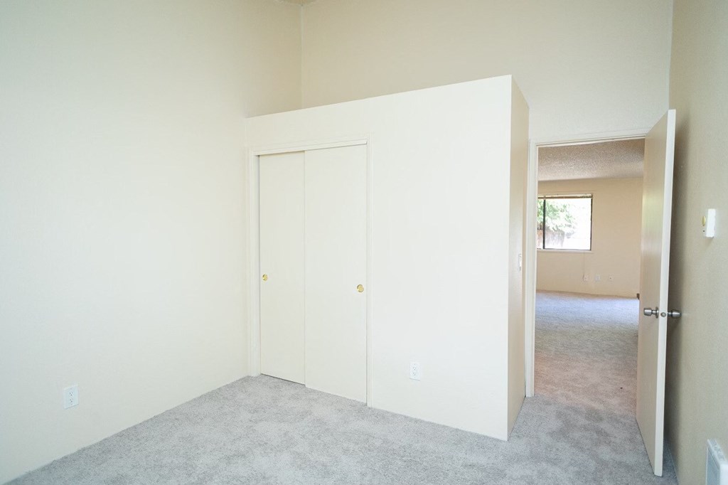 a bedroom with white walls and a white door