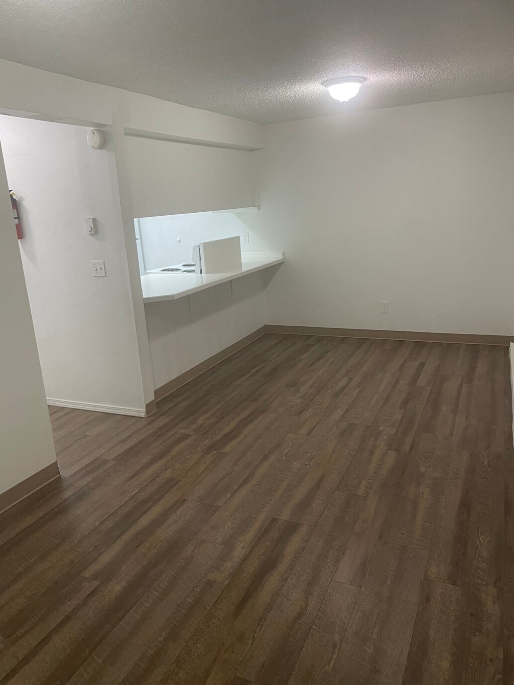 an empty room with a sink and mirror