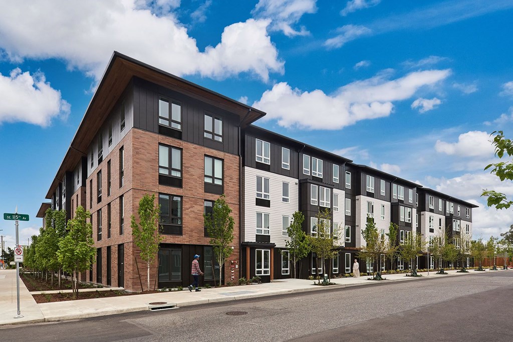 a rendering of a new apartment building on a city street