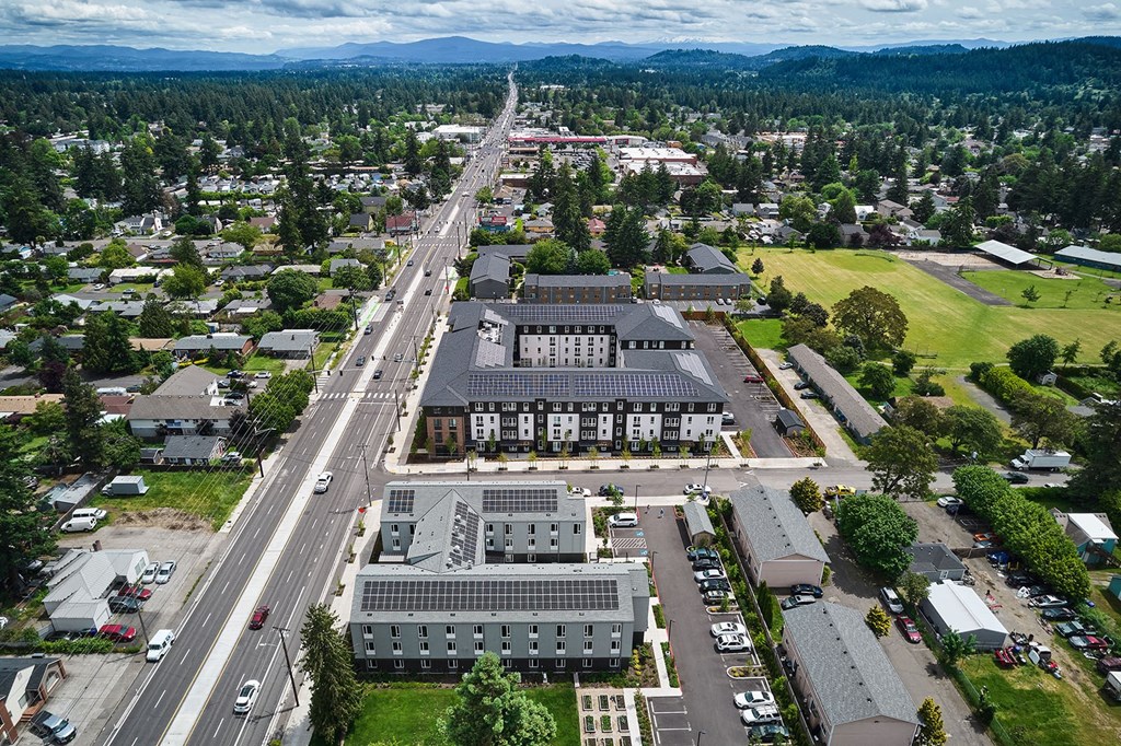 an aerial view of a city with an intersection and buildings