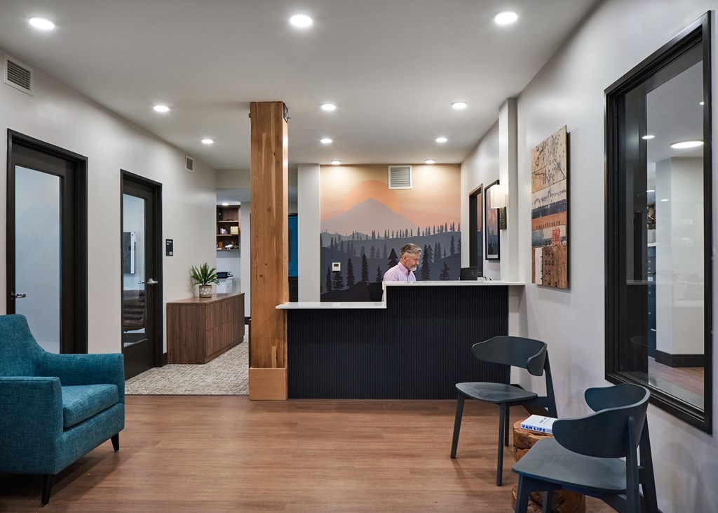a man sitting at a reception desk in a hotel lobby
