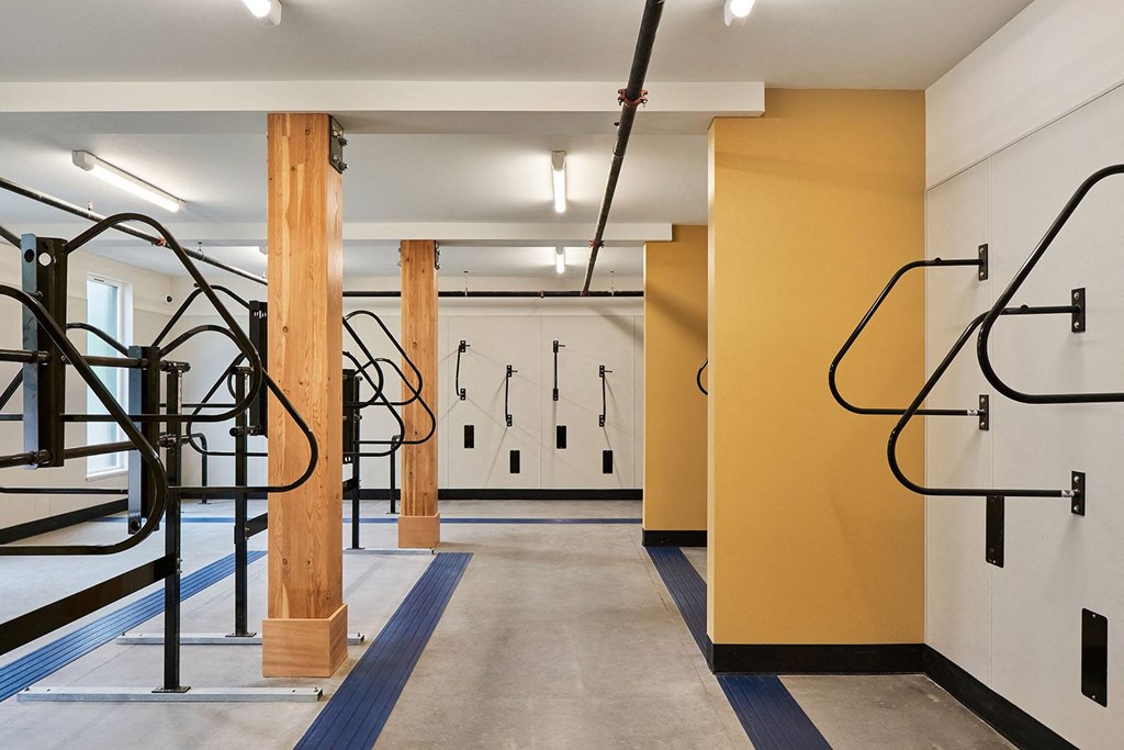 a workout room with exercise equipment and yellow walls